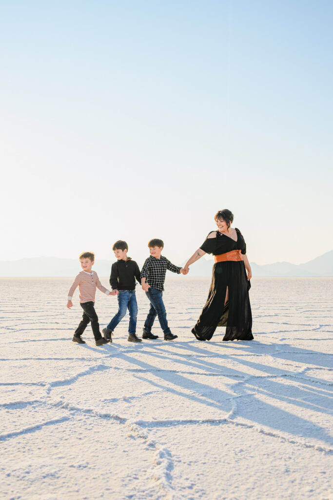 Family walking across Bonneville Salt Flats white landscape
