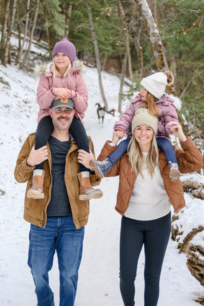 Utah family photography winter family photo outfits for Christmas Tree Family mini sessions taken by a utah family photographer in a forest in Bountiful, UT