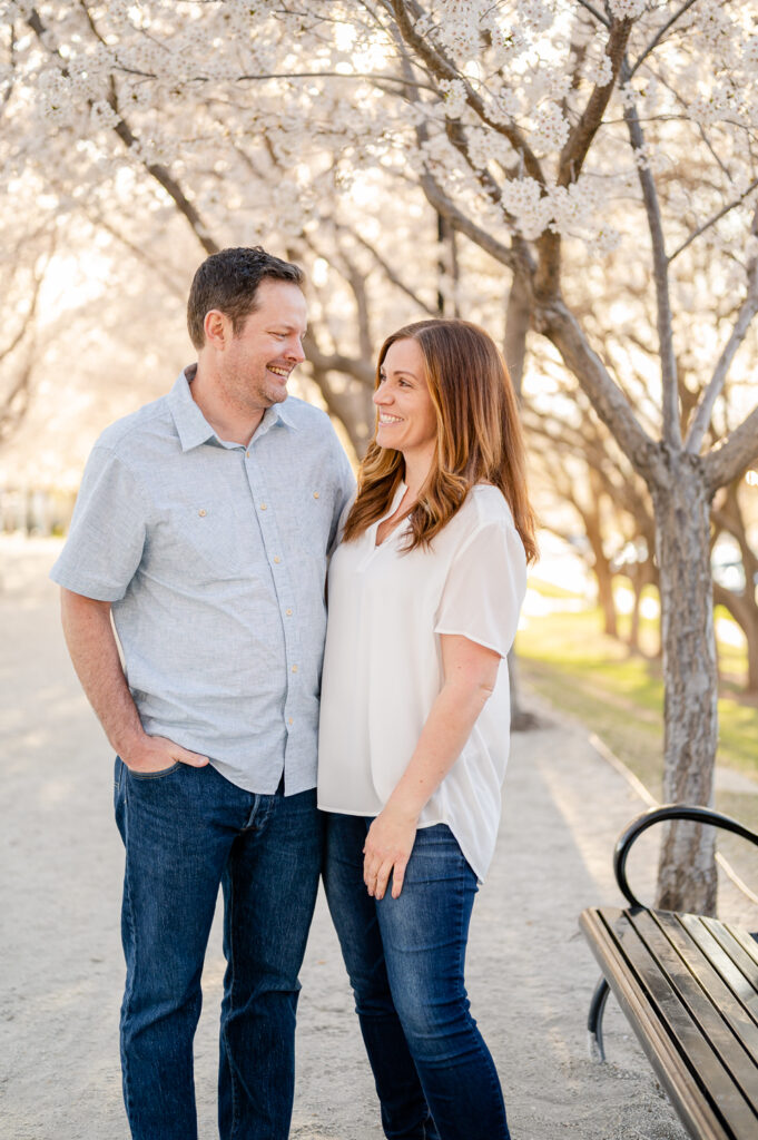 couple smiling at eachother Utah state capitol blossoms spring family photos by a utah family photographer
