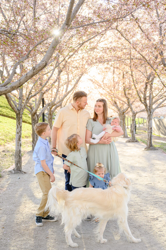 • Parents holding hands with children during blossom photo session in Salt Lake City