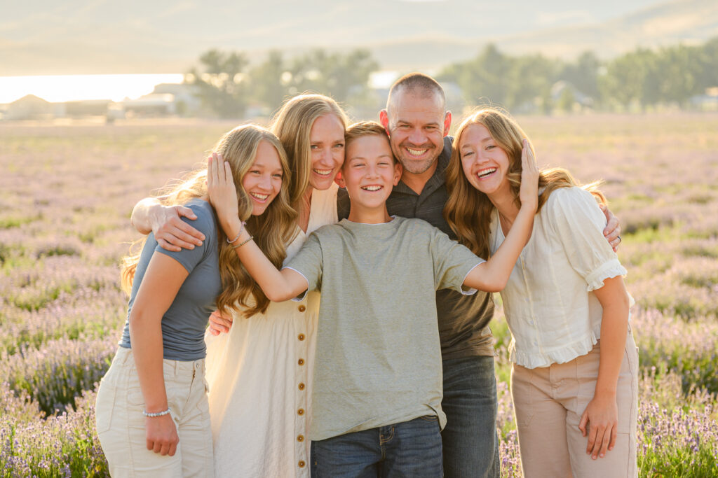 Children walking through lavender field during family photo session