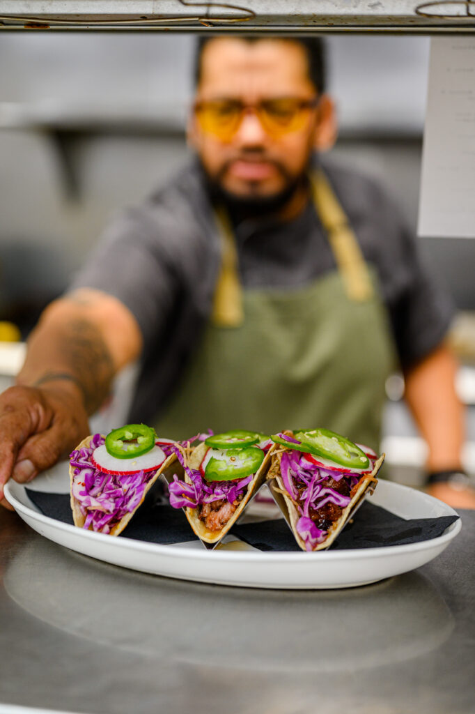 Chef plating food while preparing for commercial photography session