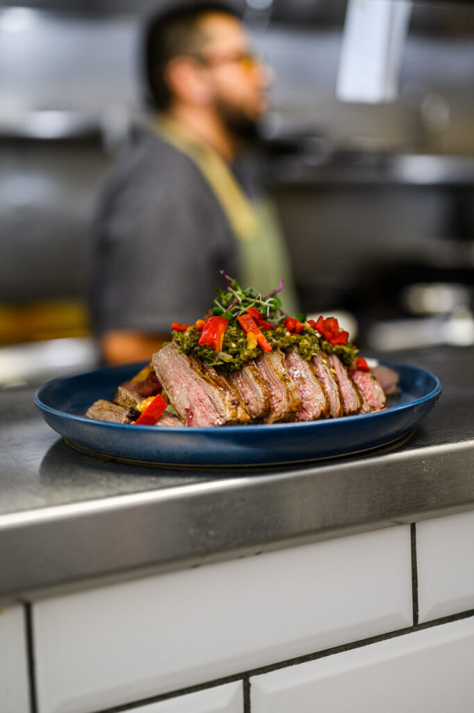 Lifestyle restaurant marketing photo showing dining atmosphere and plated meal